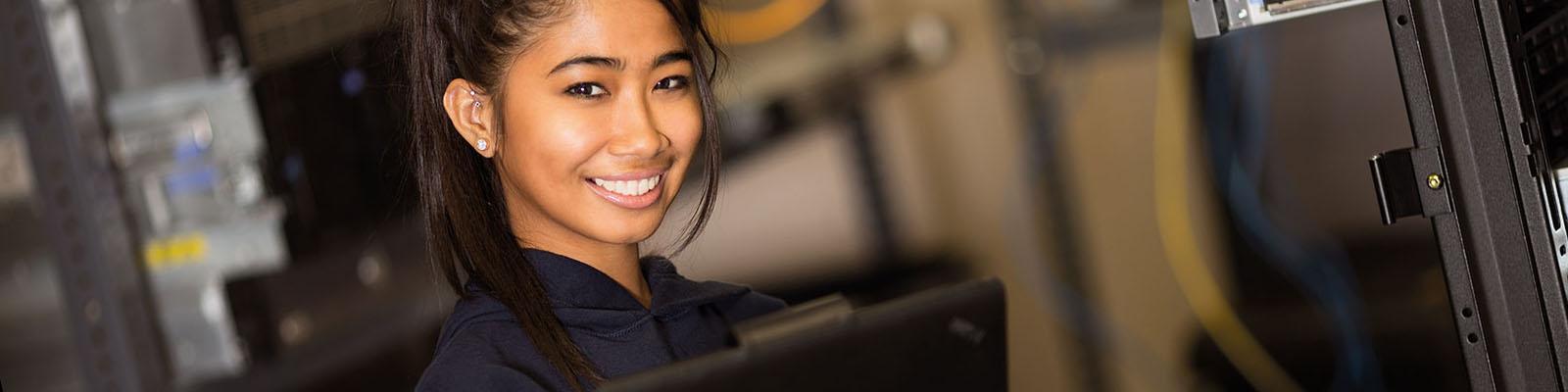 Young woman smiling in server room